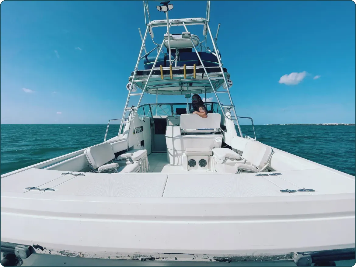 Bow seating for six on Captain Rio's 32 ft Stamas with the captain at the helm on flat blue water off Key West