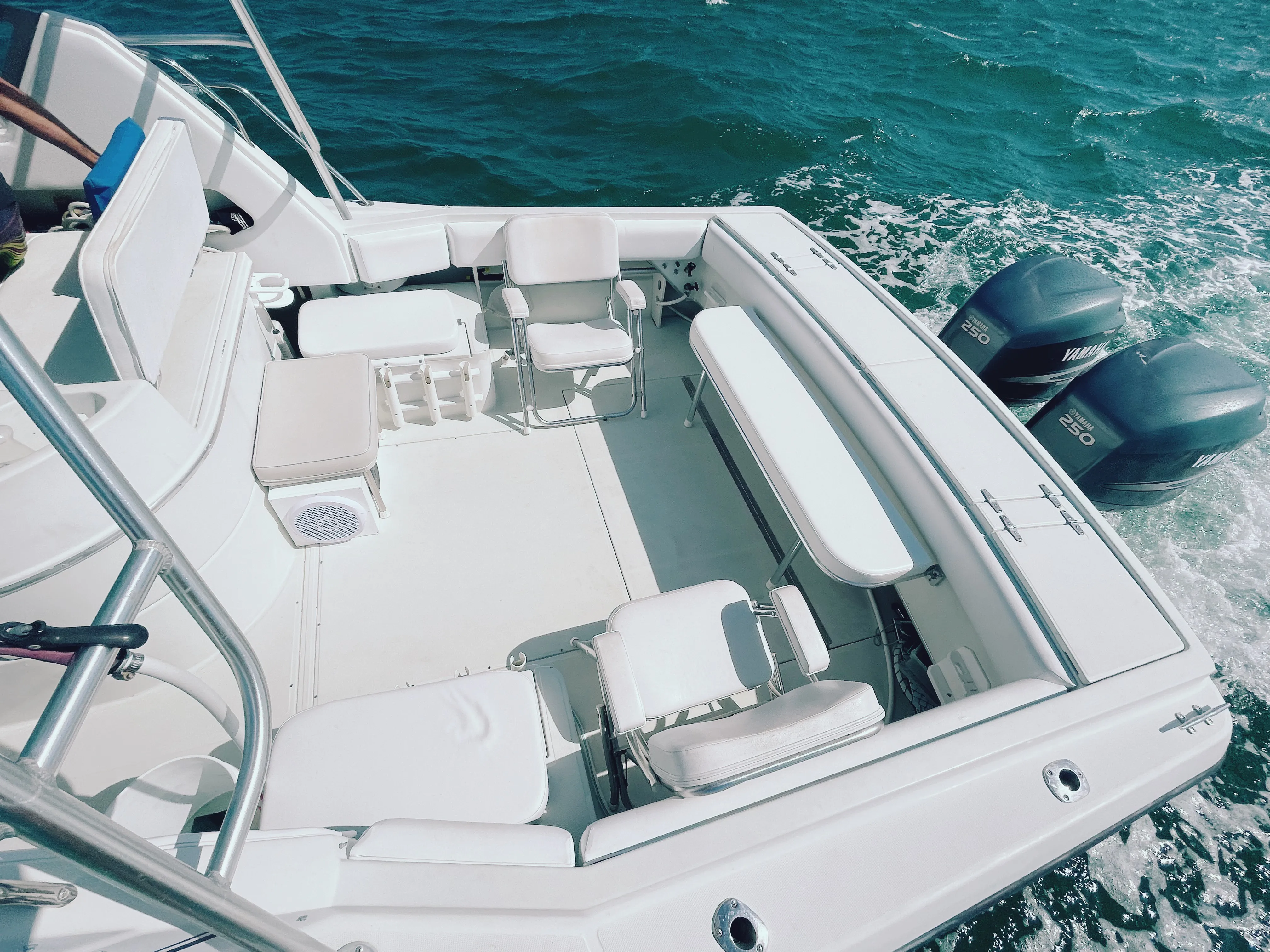 Fishing cockpit of the 32 ft Stamas with twin Yamaha 250 outboards and a wake behind