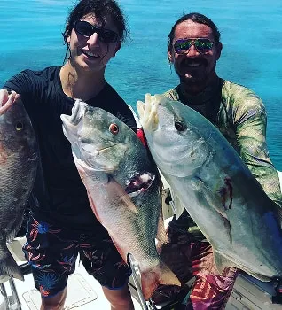 Two Captain Rio's Charters guests holding up snapper and jack caught off Key West, Florida