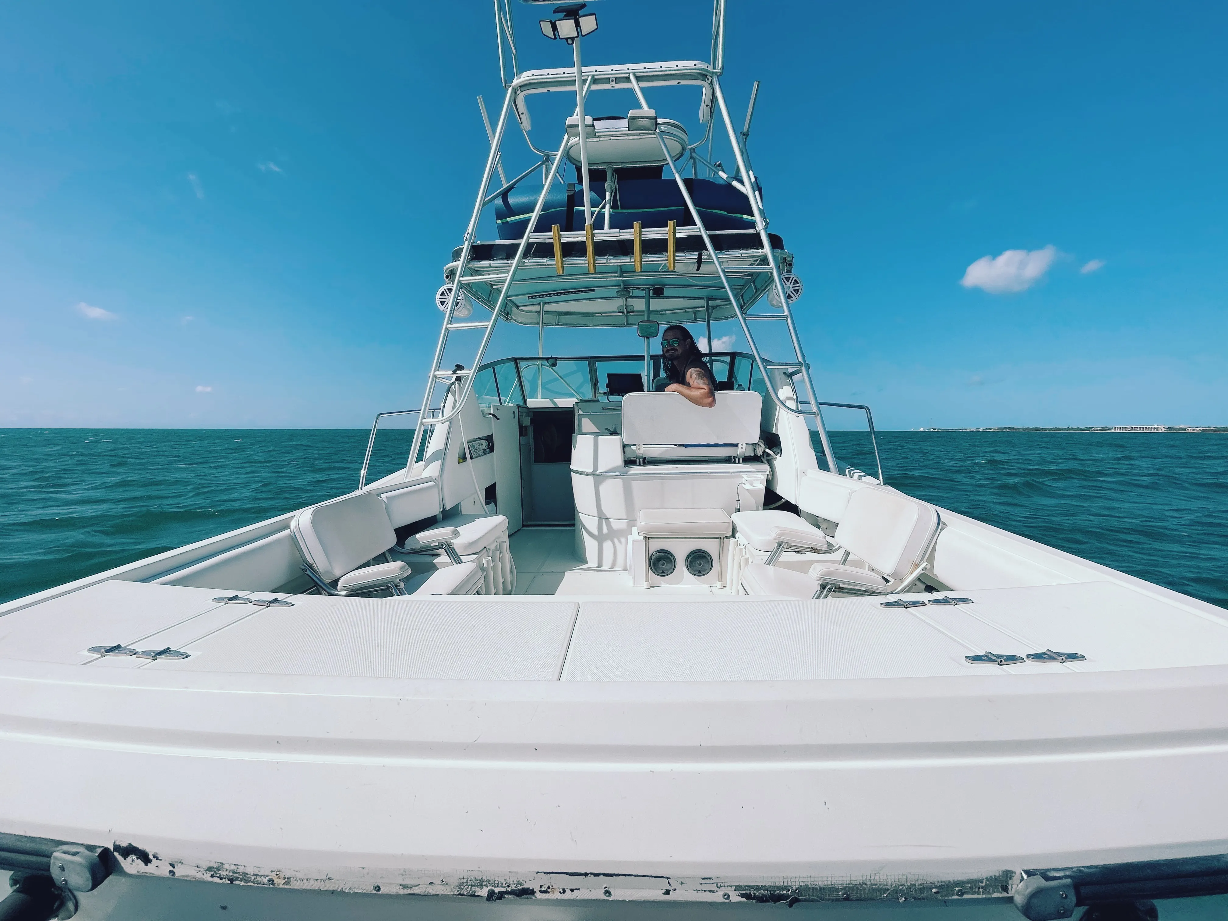 Captain Rio at the helm of his 32 ft Stamas on flat blue water off Key West, Florida